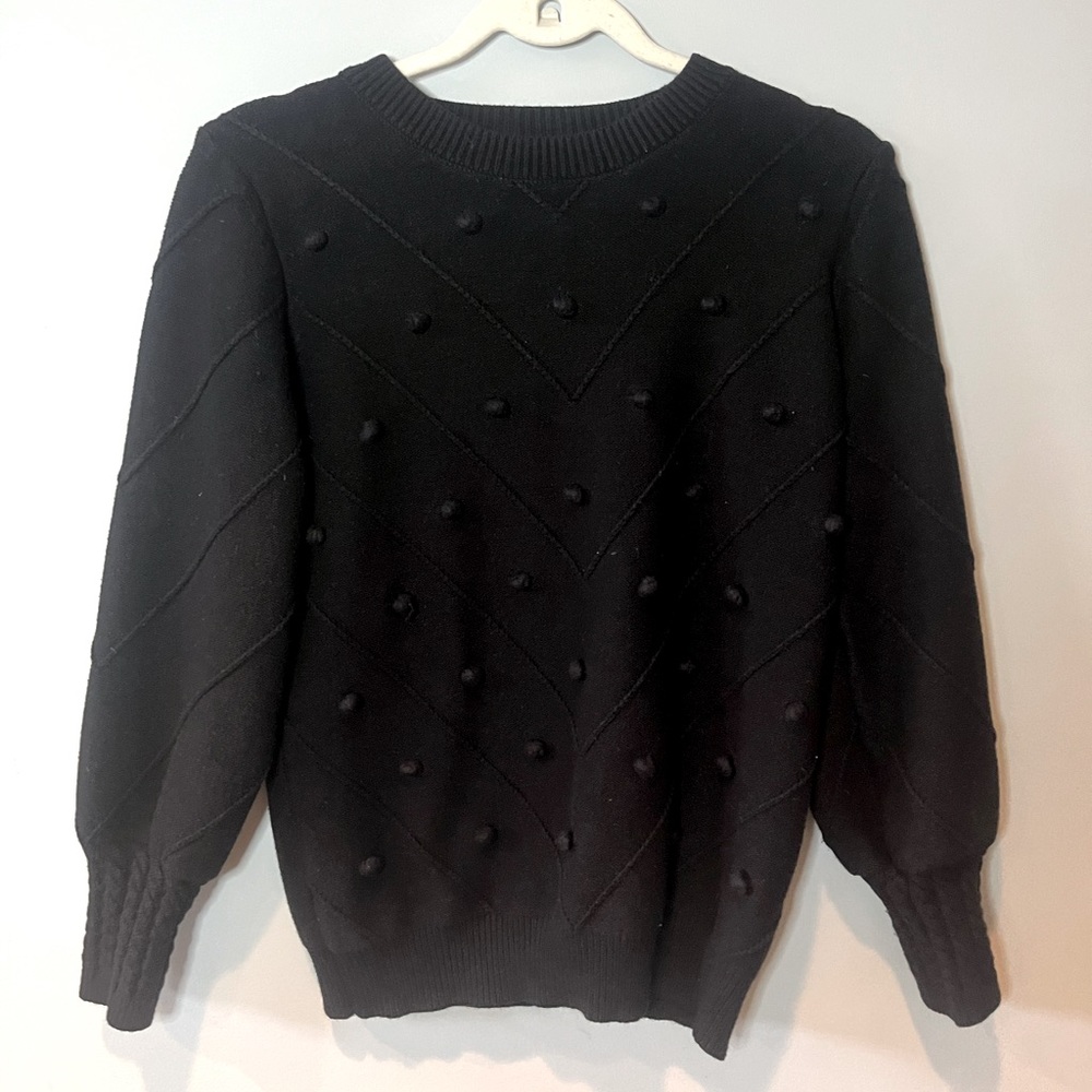 Black sweater with polka dot detailing on front
